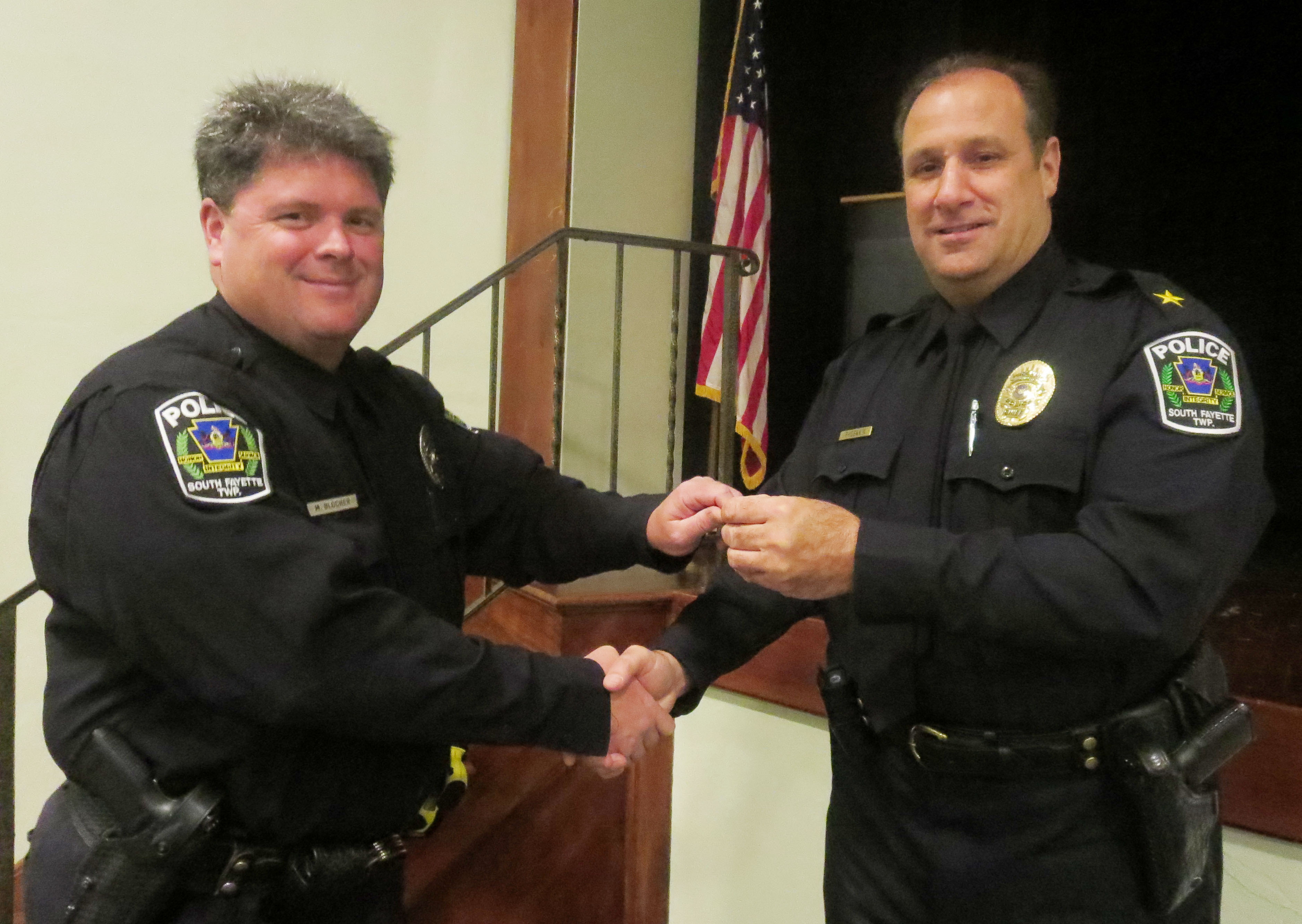 Police Chief John Phoennik presented Officer Michael Blocher with a pin for his 20 years of service.